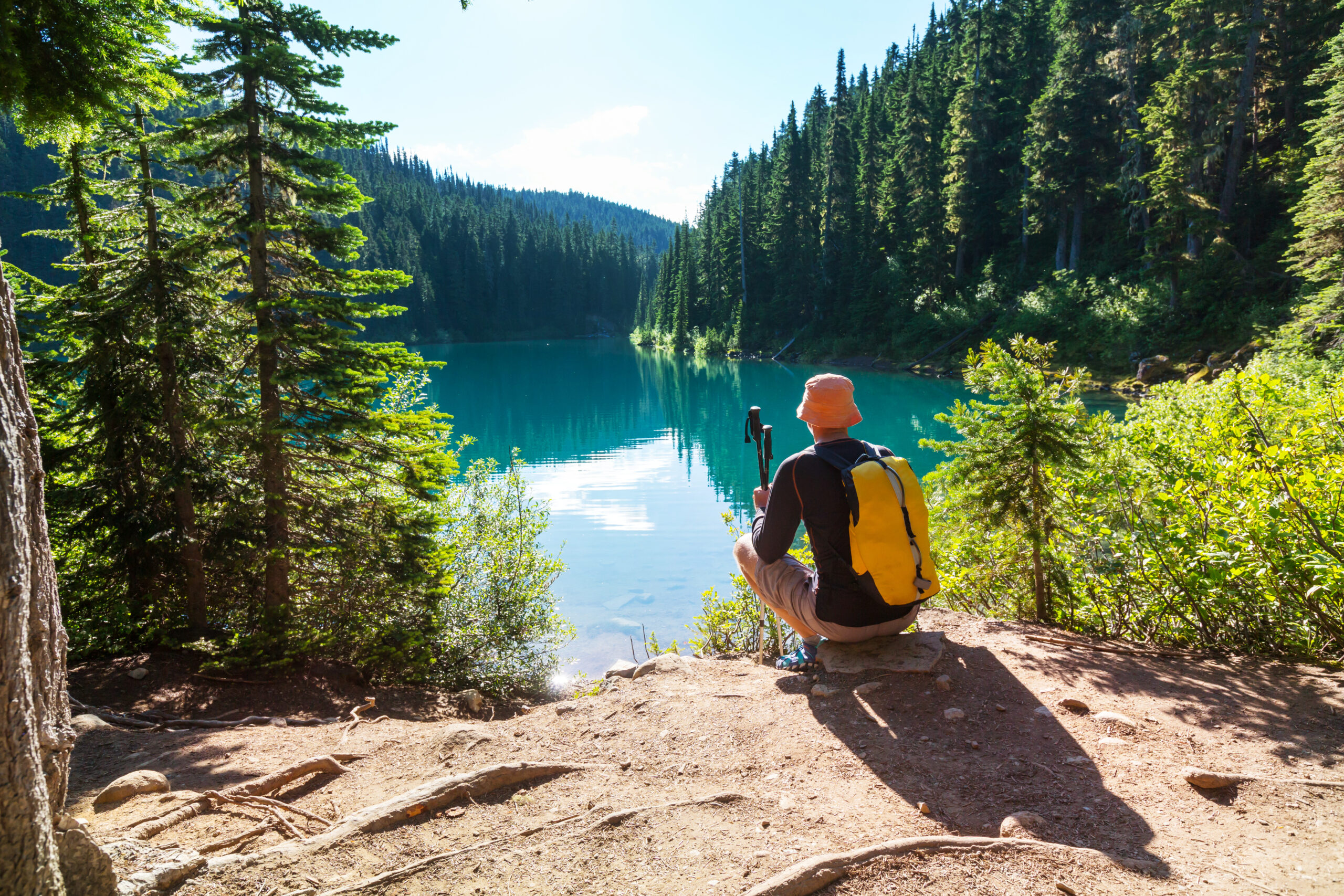 Hiking man in Canadian mountains. Hike is the popular recreation activity in North America. There are a lot of picturesque trails.